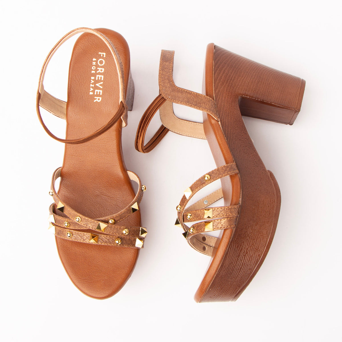 Brown block heel sandals for women, gold pyramid and dome studs scattered across three croc-embossed crossover straps, an elasticated ankle loop, and a wood-grain platform and block heel