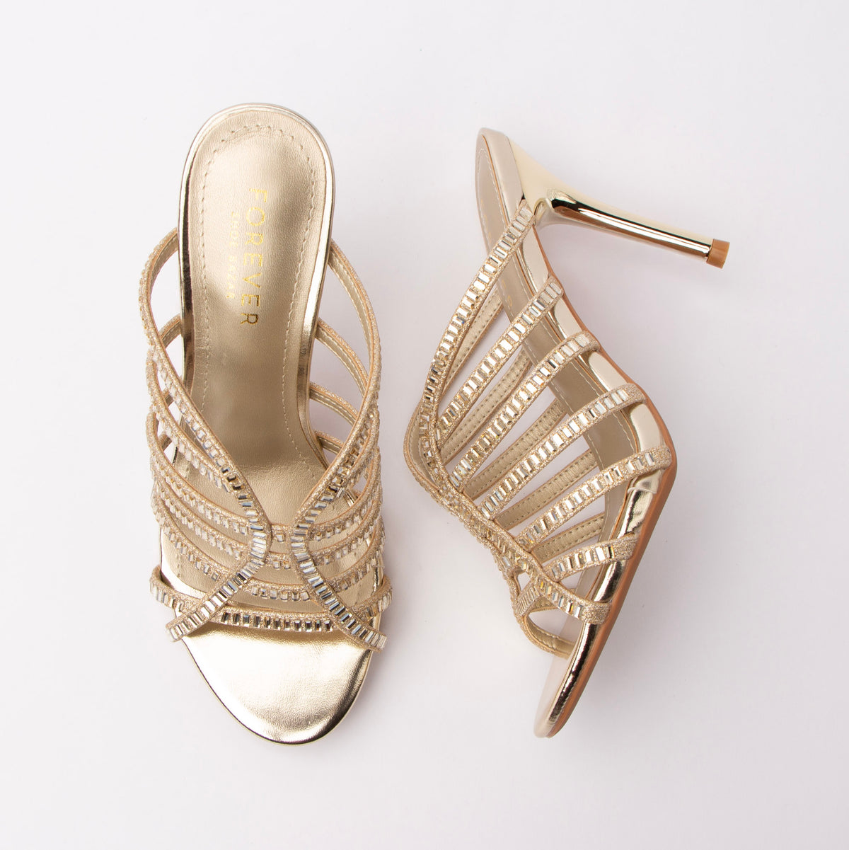 Gold mules for women, both shoes laid flat