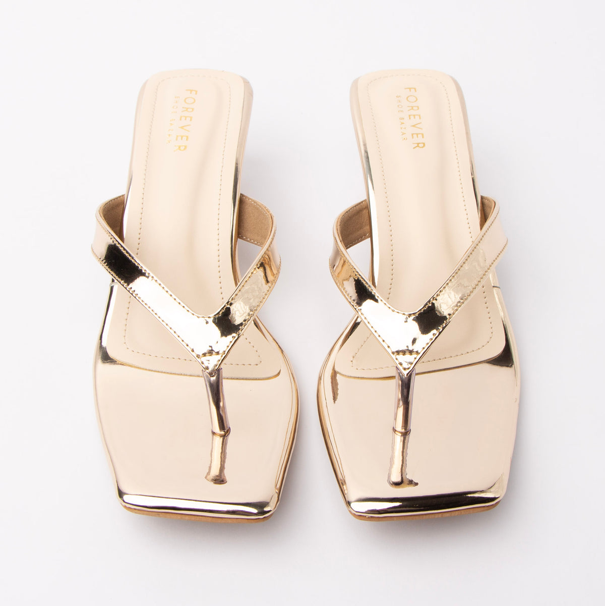 Gold toe-post kitten heel mules for women, both shoes from the front