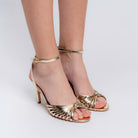 Gold stiletto heels for women with woven front strap and ankle strap