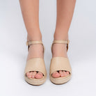 Beige woven wedge sandals for women with cushioned footbed and buckle ankle strap